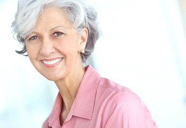 Smiling senior woman wearing pink blouse